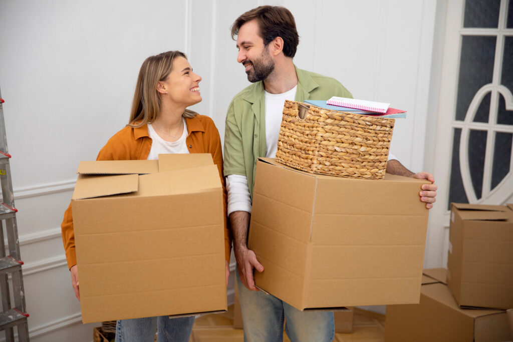 Un couple déchargeant des cartons lors d'un emménagement en logement de fonction.