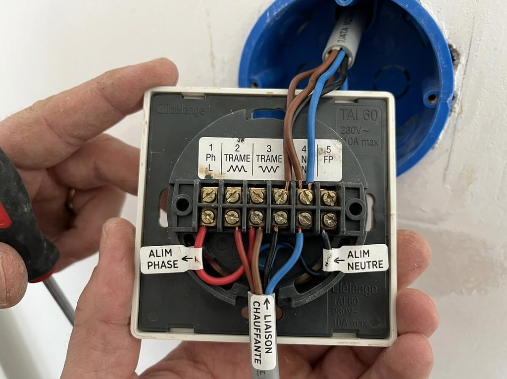 Bornier de raccordement arrière du thermostat TAI 60 avec alimentation phase neutre et trame chauffante.